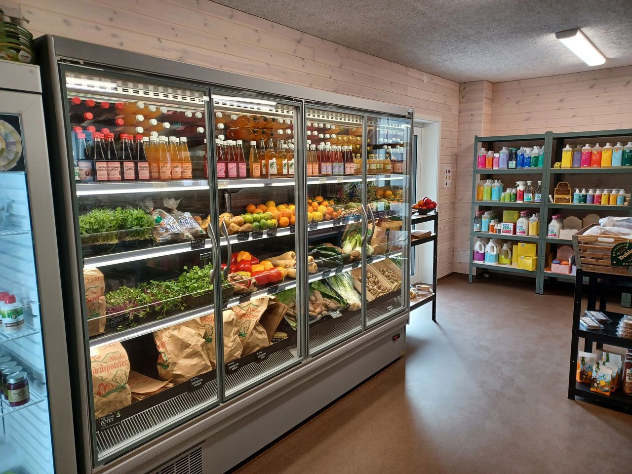 Refrigerated shelves with organic vegetables, fruit and drinks from the school farm at the SJH Farm Shop.