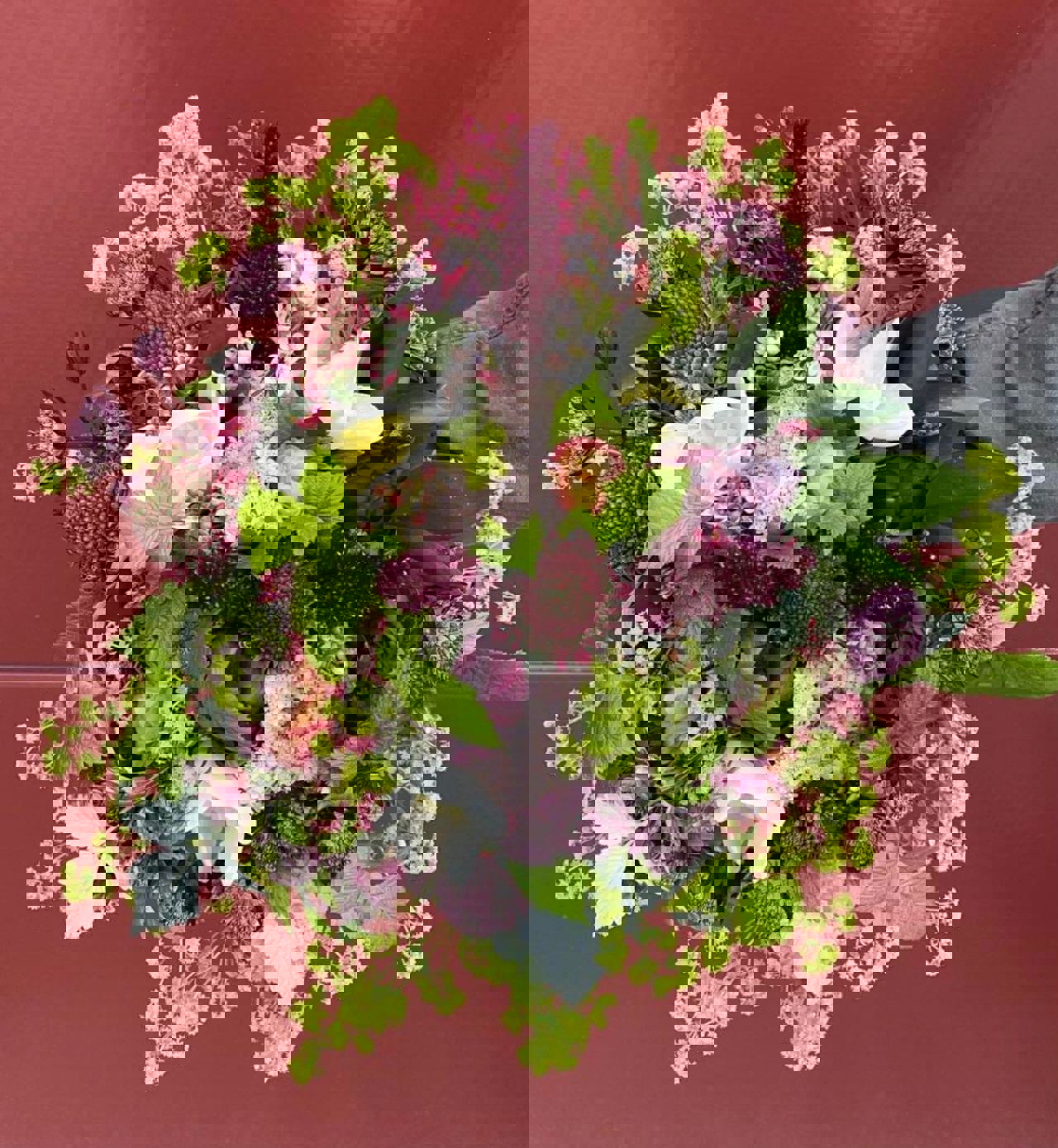 Colourful seasonal bouquet with green, purple, white and pink flowers created by the floral department at SJH.